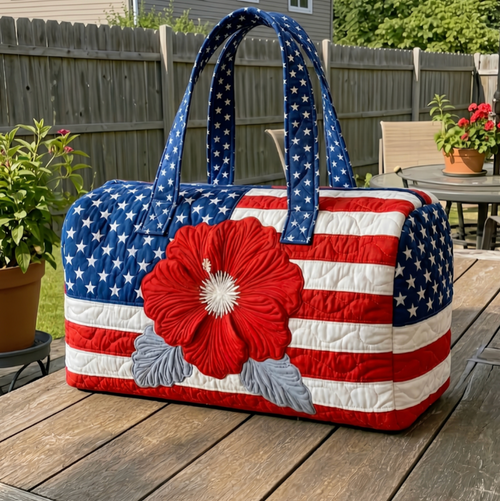 American flag patterned handbag with a red flower on a wooden surface outdoors.